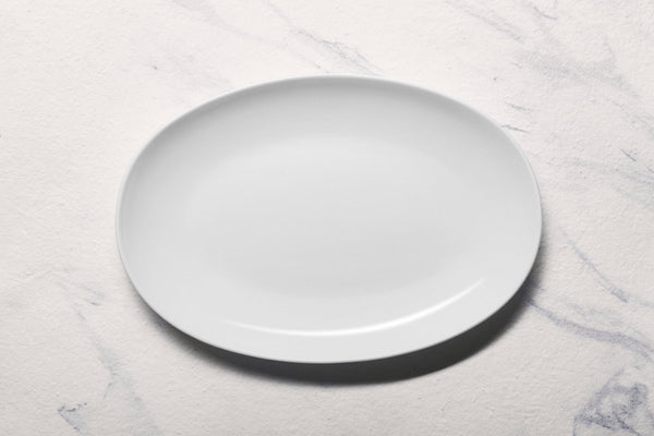 Ariane 14 1/6" Vital Coupe - Warm White Porcelain Coupe Oval Plate - 6/Case (AVCARN000015036) - iFoodservice Online