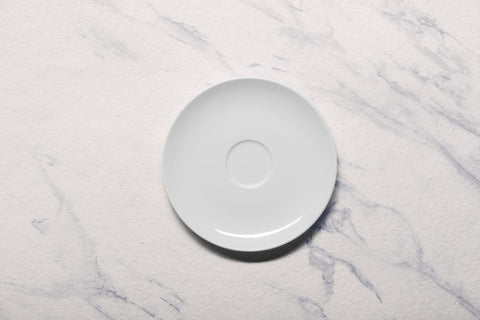 Ariane 5 1/8" Vital Coupe - Warm White Porcelain Coupe Round Rimless Espresso Saucer - 12/Case (AVCARN000014001) - iFoodservice Online