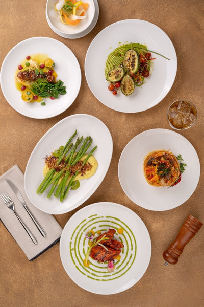 Ariane Vital Coupe 12 3/5" Vital Coupe - Warm White Porcelain Coupe Oval Plate - 6/Case (AVCARN000015032) - iFoodservice Online