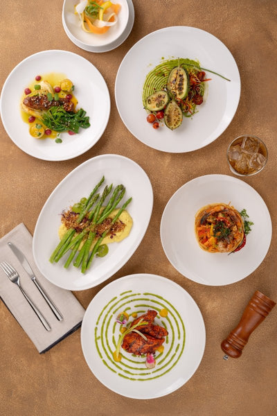 Ariane Vital Coupe 7" Vital Coupe - Warm White Porcelain Coupe Round Rimless Plate - 12/Case (AVCARN000011018) - iFoodservice Online